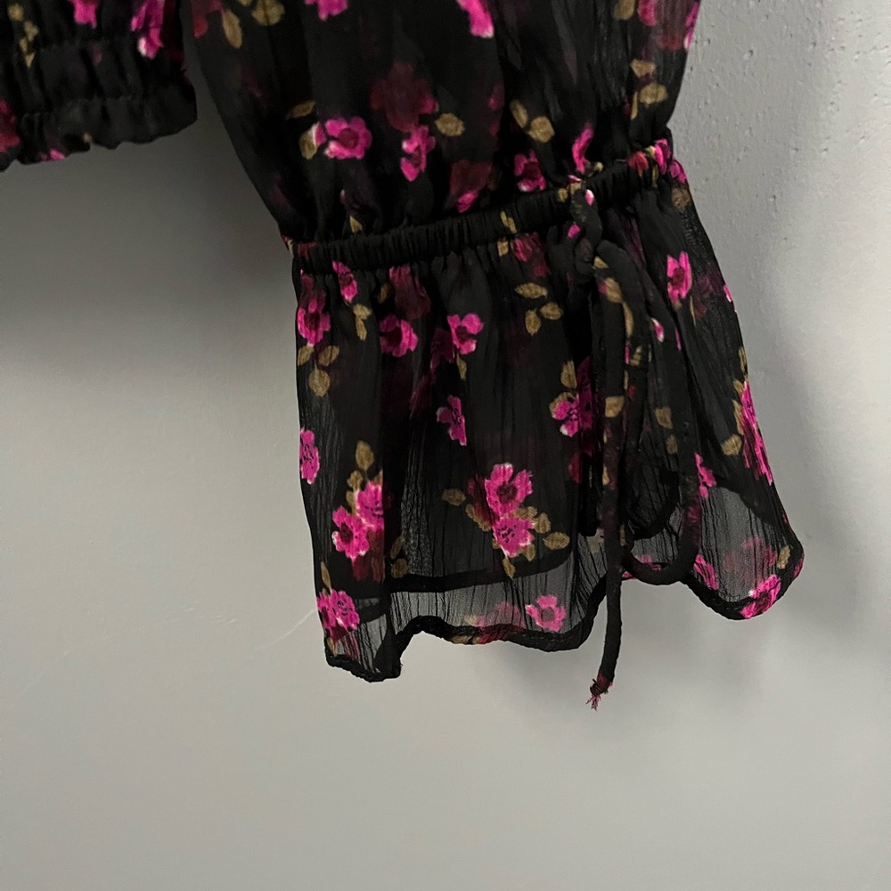 Express floral blouse. Blouse has slightly belled sleeves with an elastic bottom